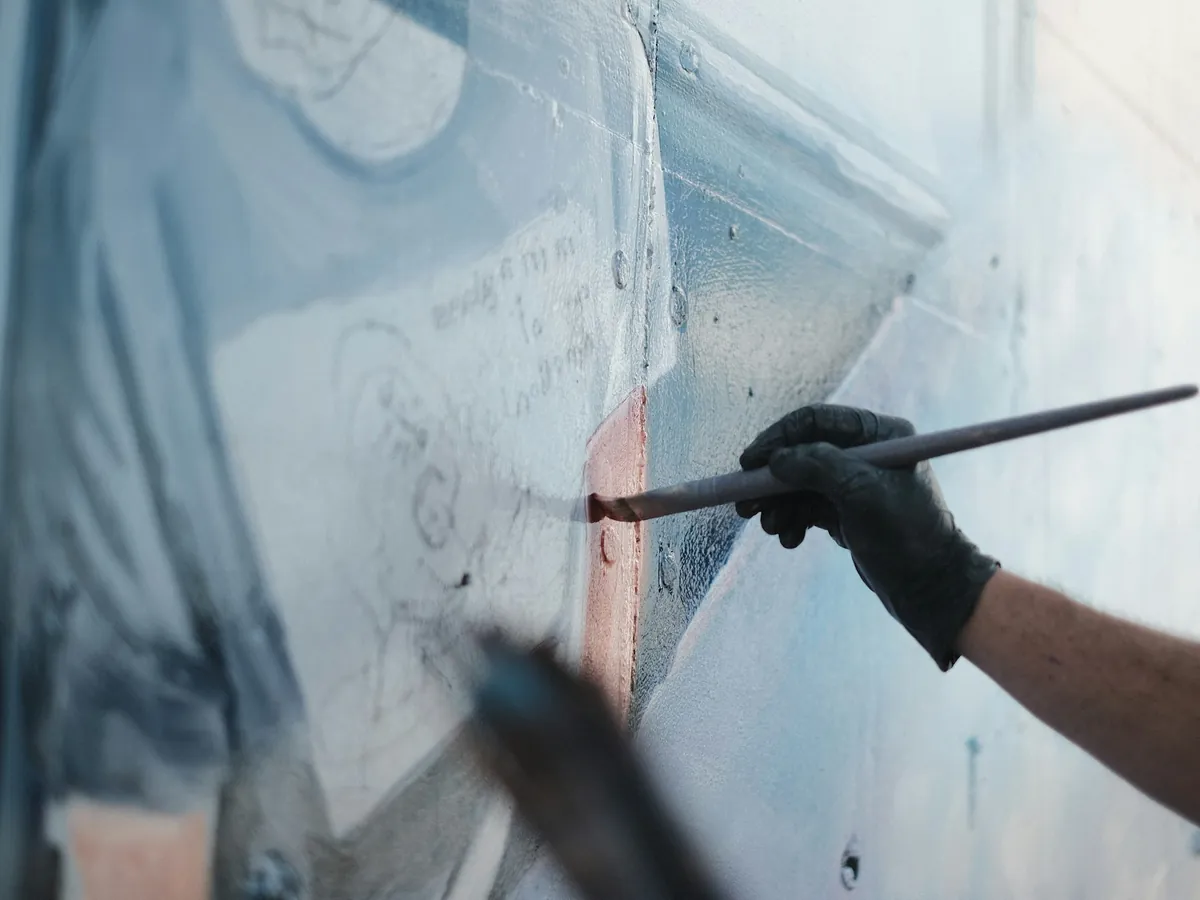 A gloved hand preparing a panel