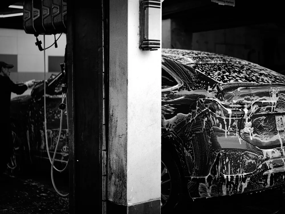 A car washed in a covered bay
