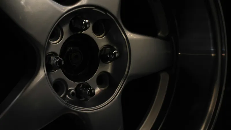 A dark alloy wheel and tire