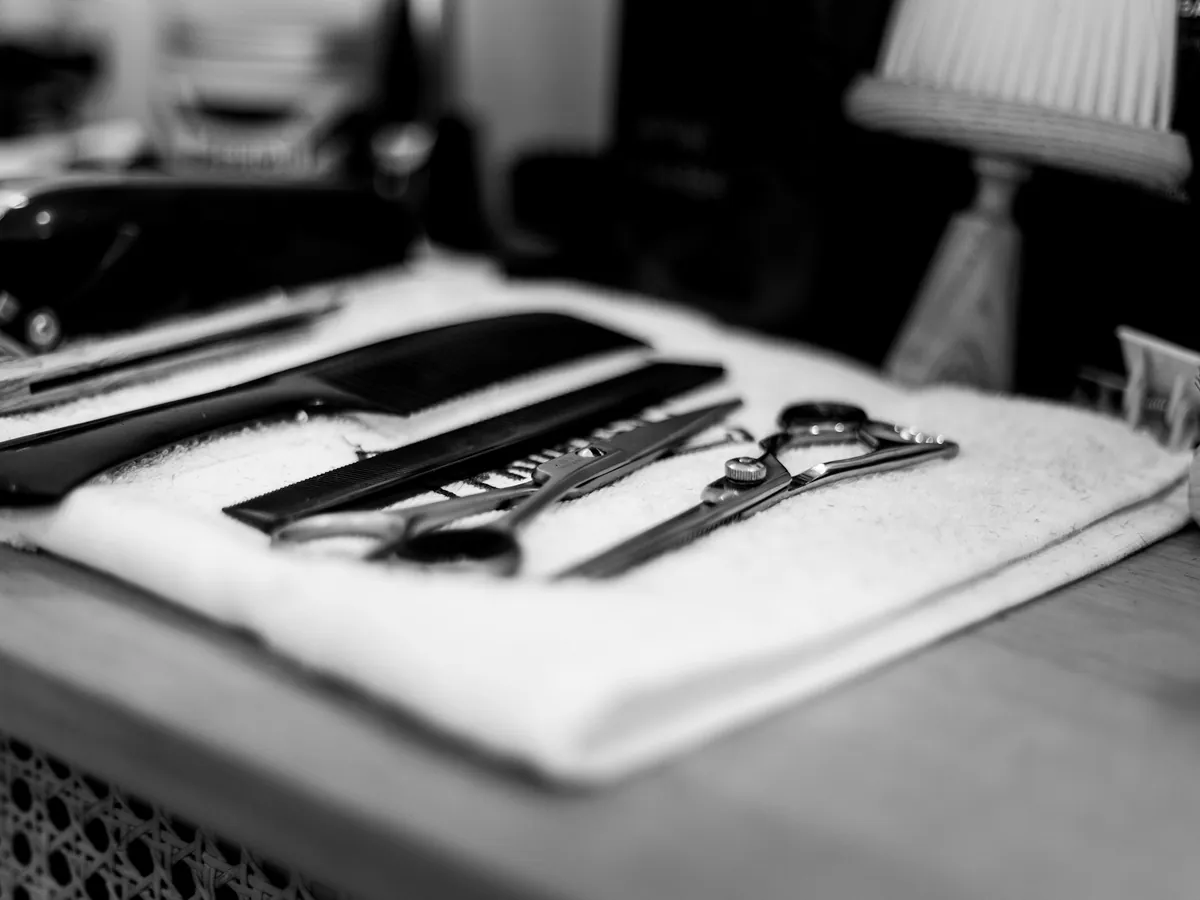 Barber scissors and a comb on a towel