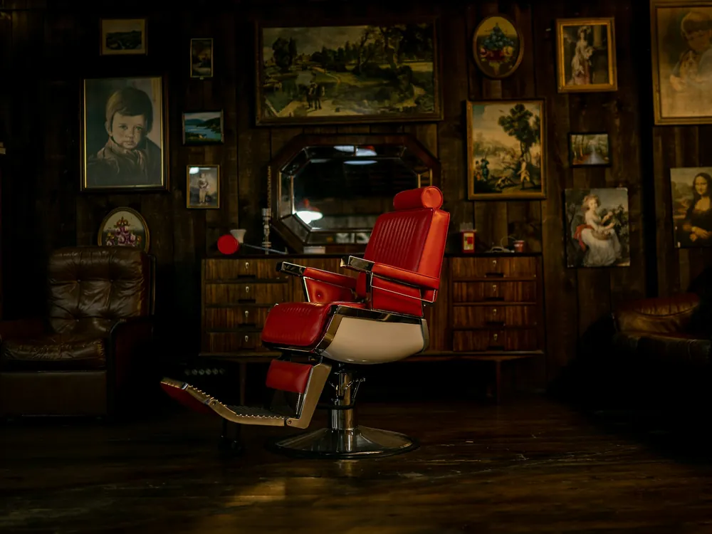 A barber chair in a dark shop