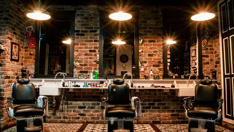 Barber chairs in a brick-walled shop