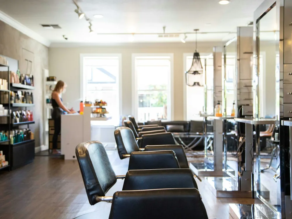 A salon floor with styling chairs