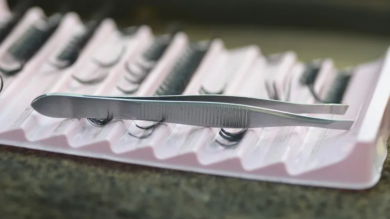 Tweezers on a tray of lash extensions