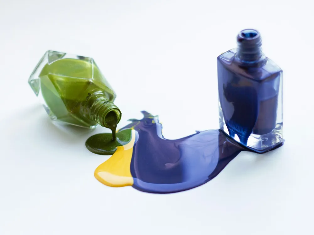 A spilled bottle of blue nail polish
