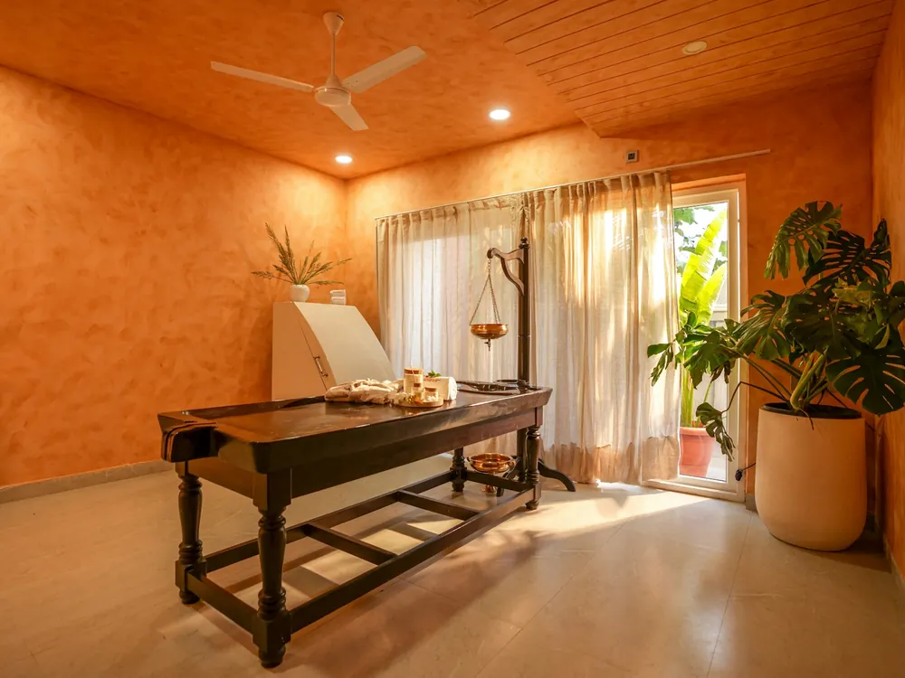 A warm treatment room with a massage table