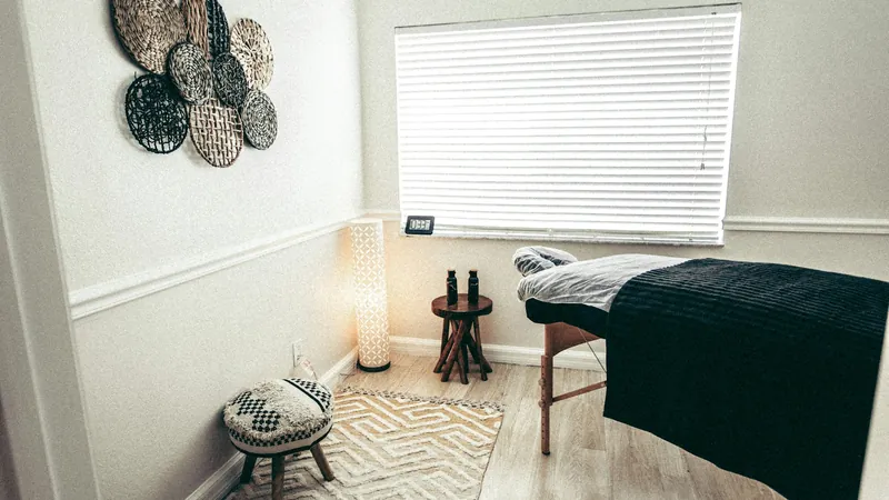 A calm treatment room with a massage table