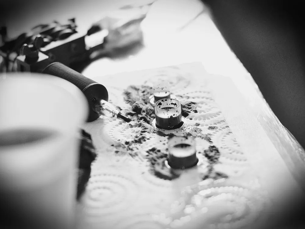 A tattoo machine over a stencil