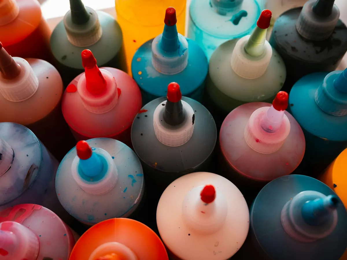 Rows of coloured tattoo ink bottles