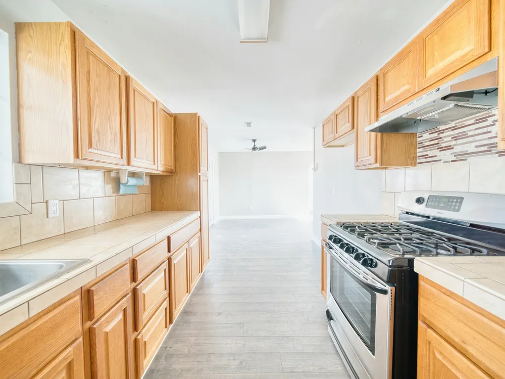 A kitchen with a stove and sink