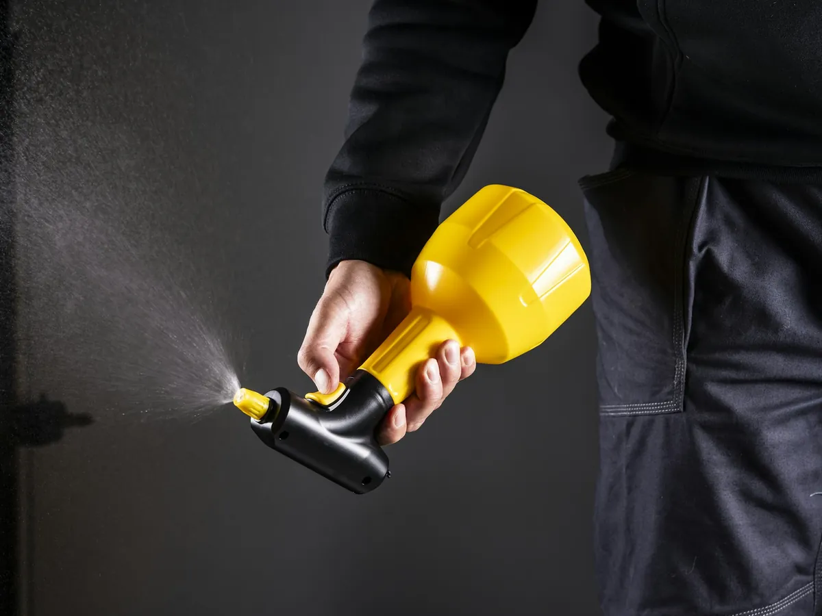 A hand holding a sprayer