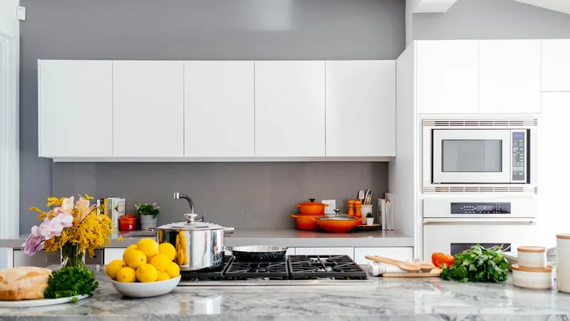 A clean white kitchen with an island