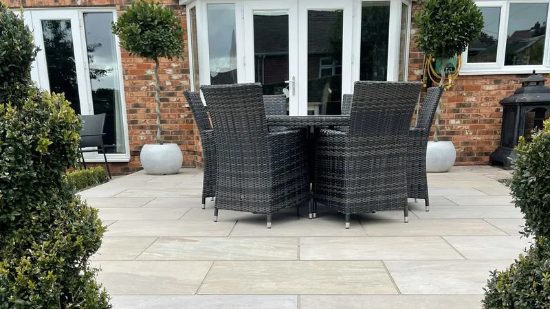A stone patio with outdoor furniture