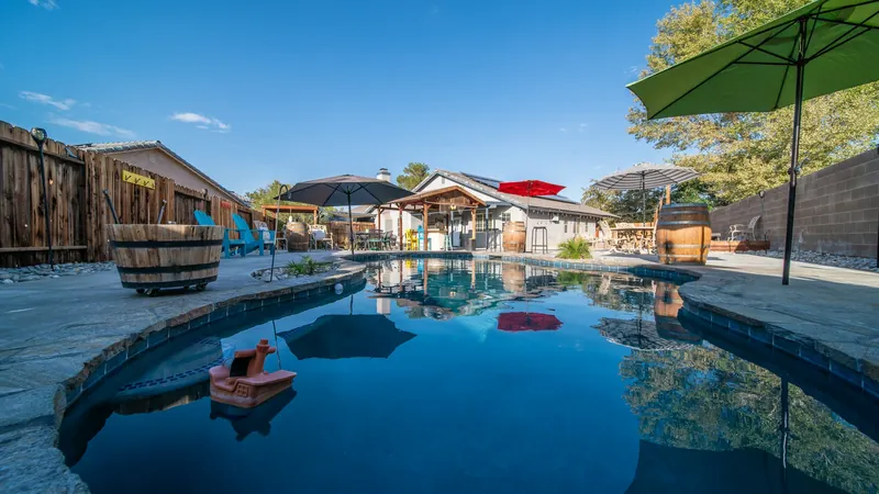 A backyard pool with an umbrella
