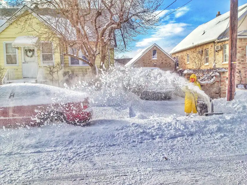 A snow blower throwing snow