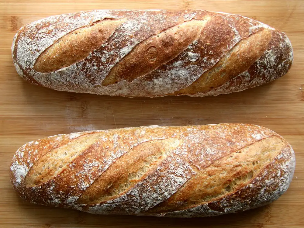 Two baguettes on a wooden table