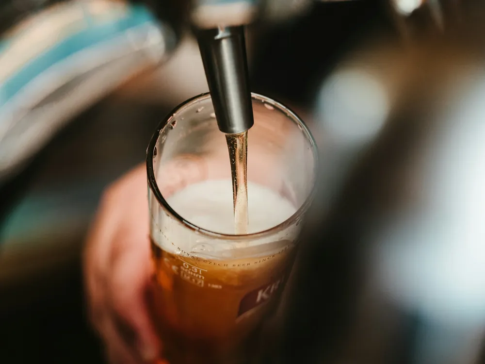 Beer poured from a tap into a glass