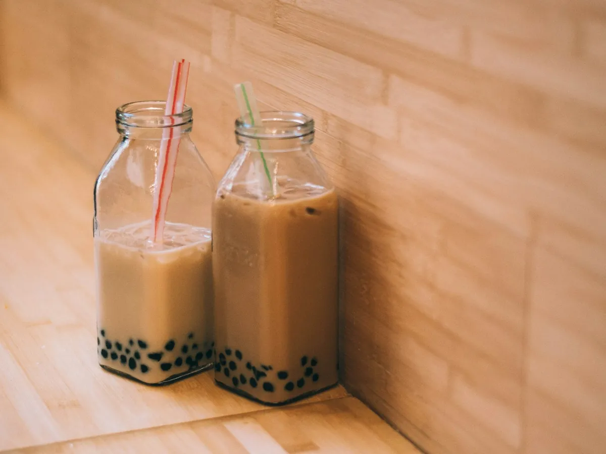 Two milk teas with straws