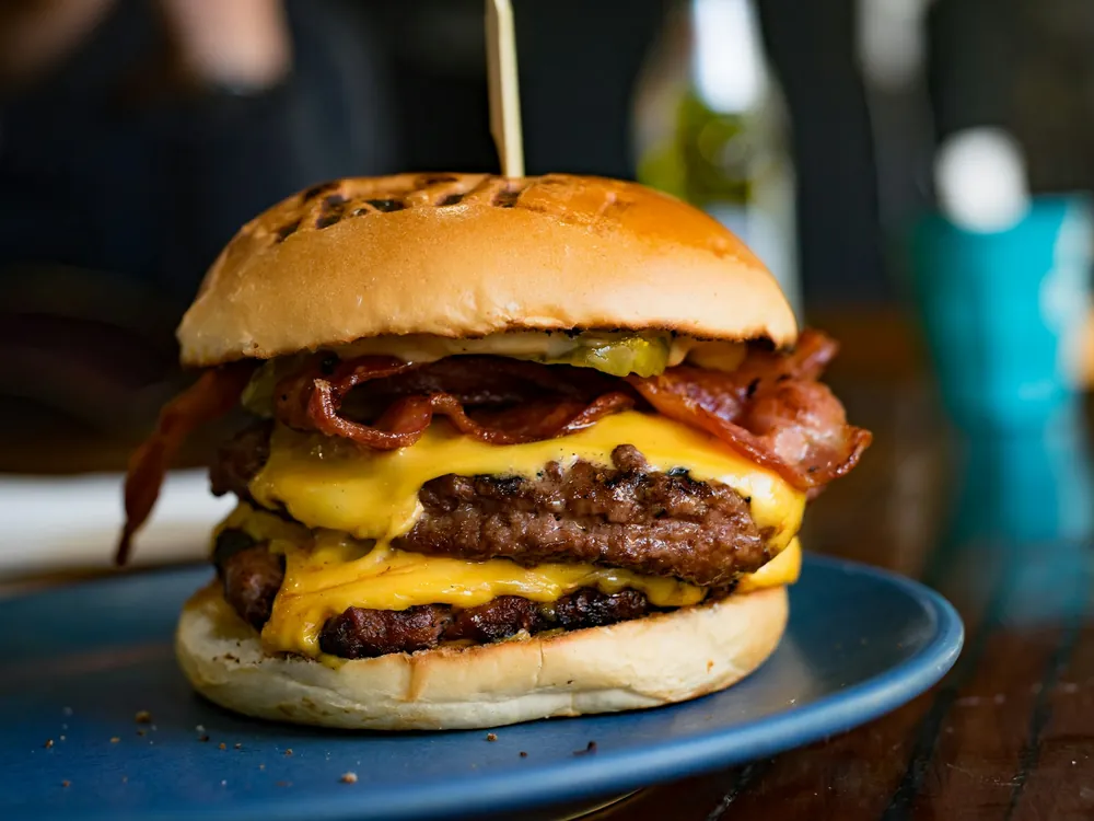A bacon cheeseburger on a plate