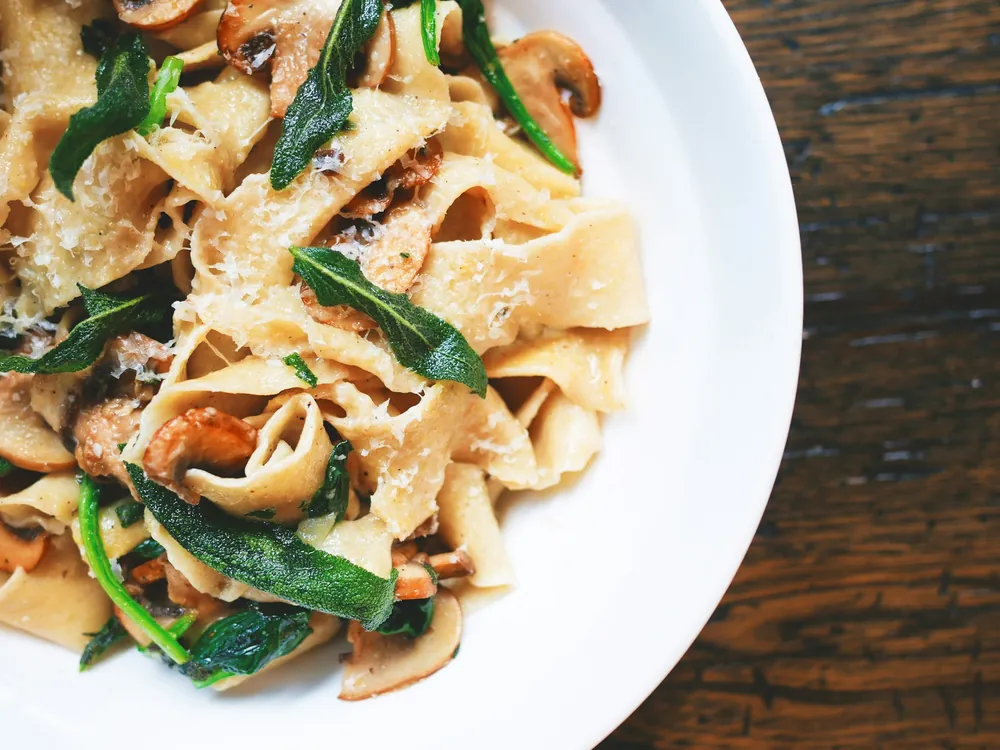 A plate of pasta with greens