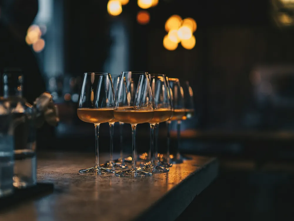 Glasses lined up on a bar