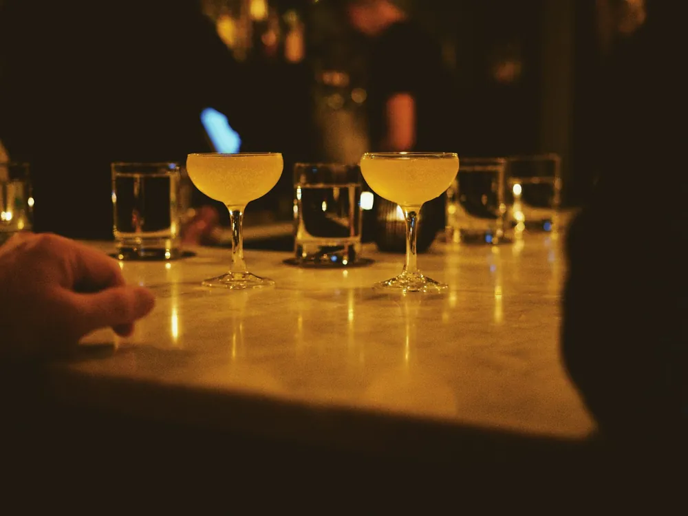 Cocktail glasses lit on a counter
