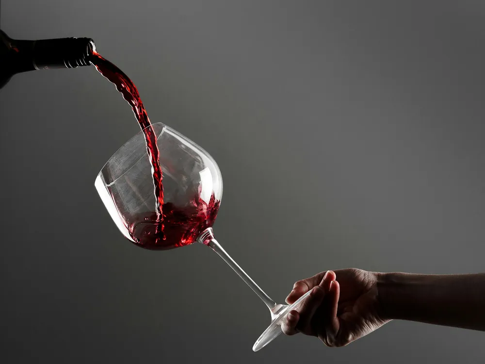 Red wine poured into a glass