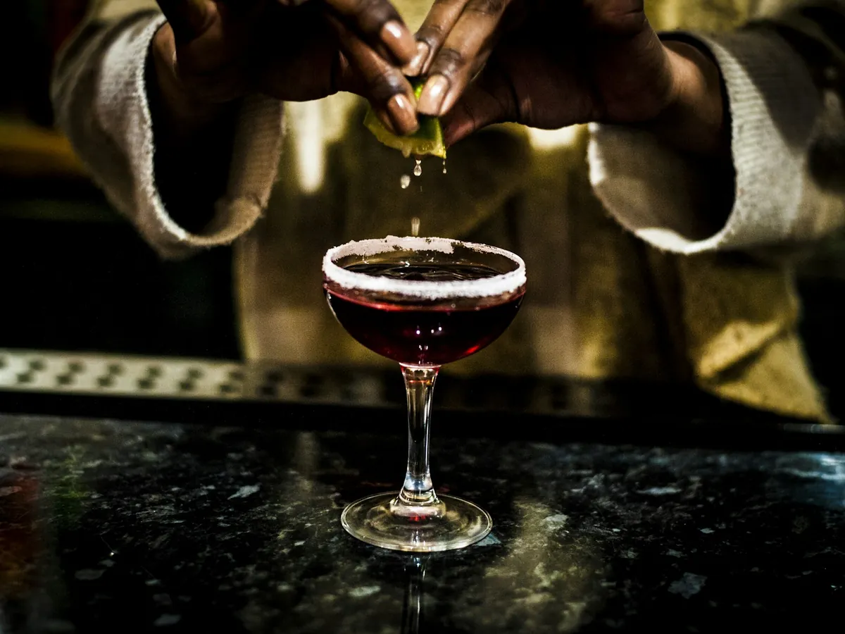A cocktail being garnished at the bar