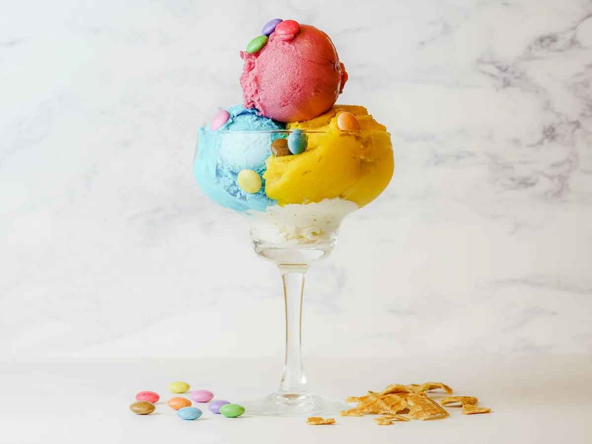 Ice cream scoops in a glass with a cherry