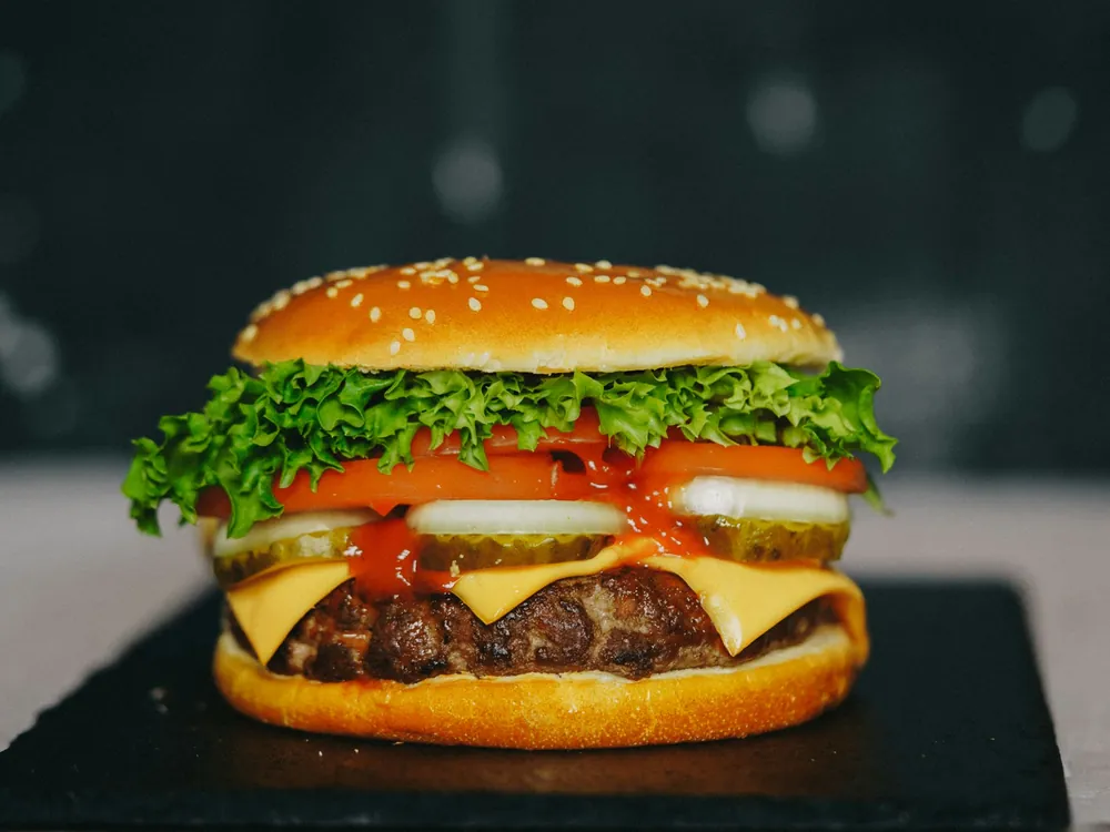 A burger with lettuce and tomato