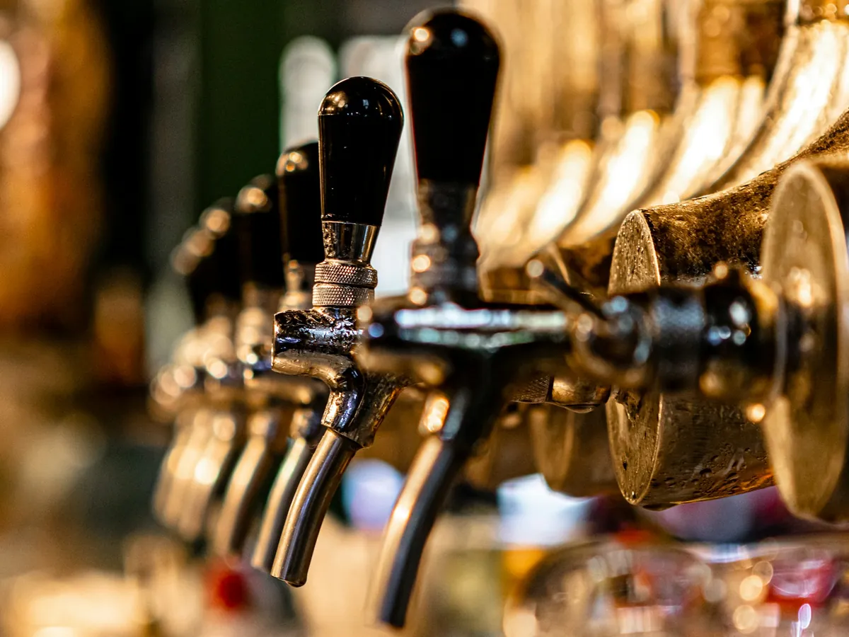 A row of brass beer taps