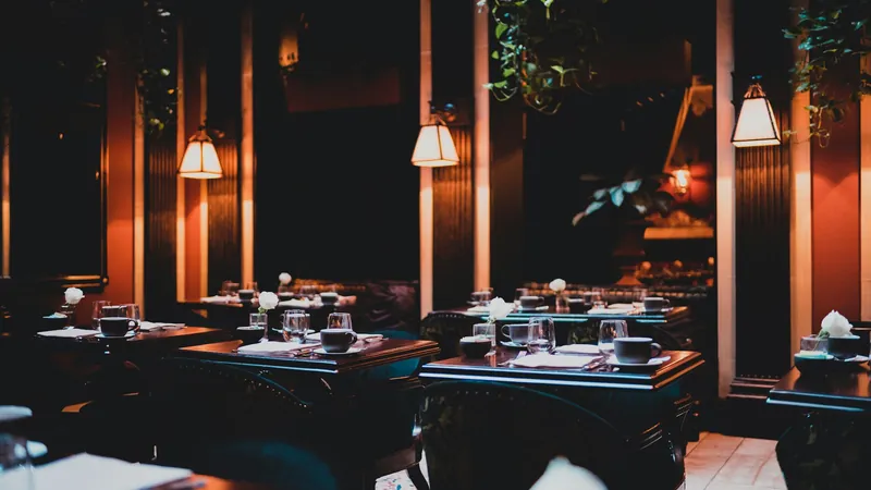 A dark dining room lit by low lamps