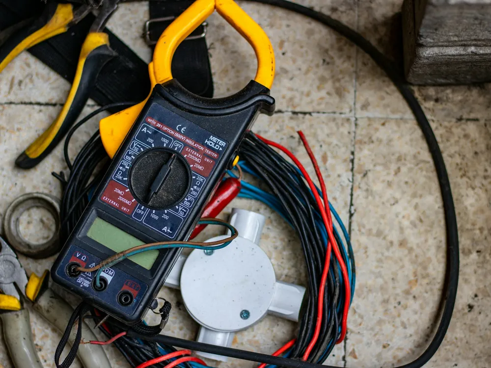 A clamp meter on a work surface