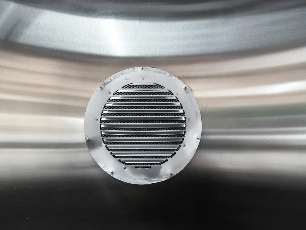 A round metal vent grille