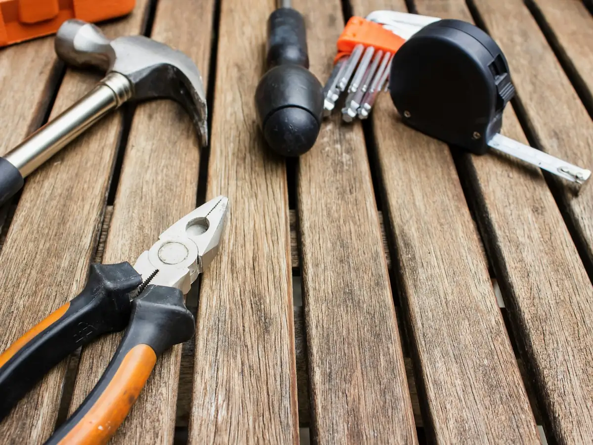 Hand tools laid on a wooden deck
