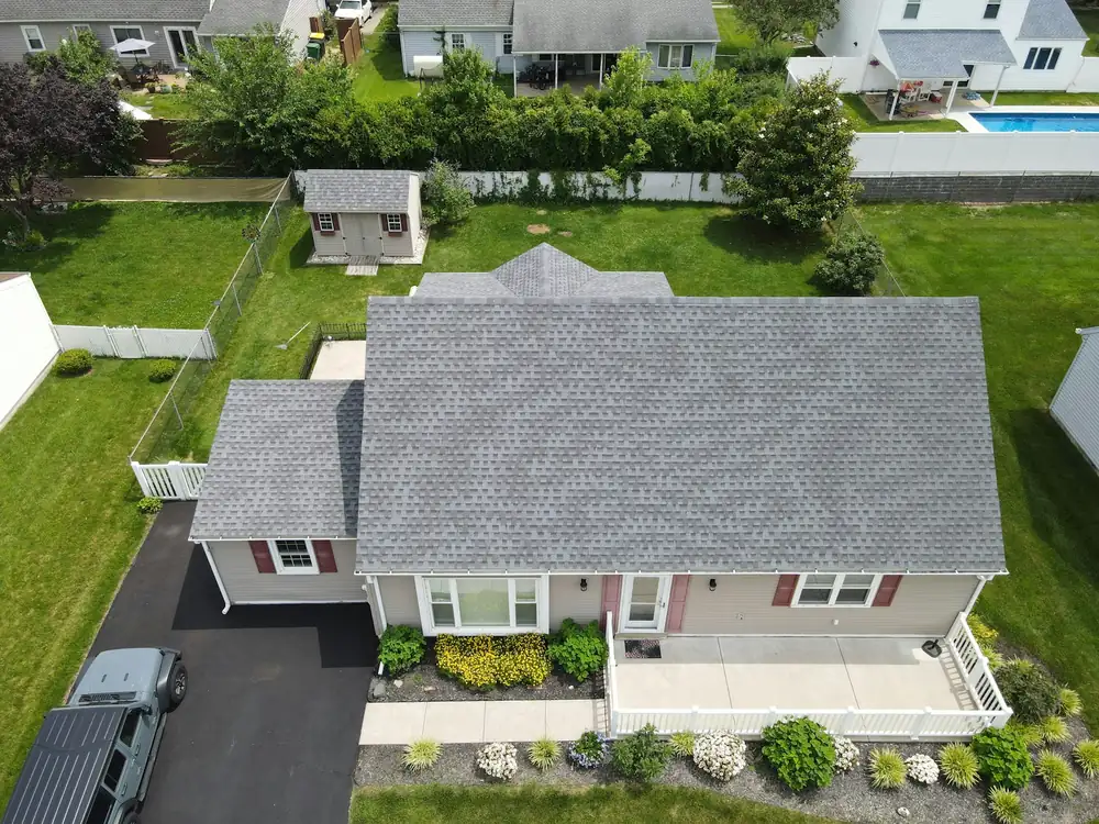 An aerial view of a house with a grey roof